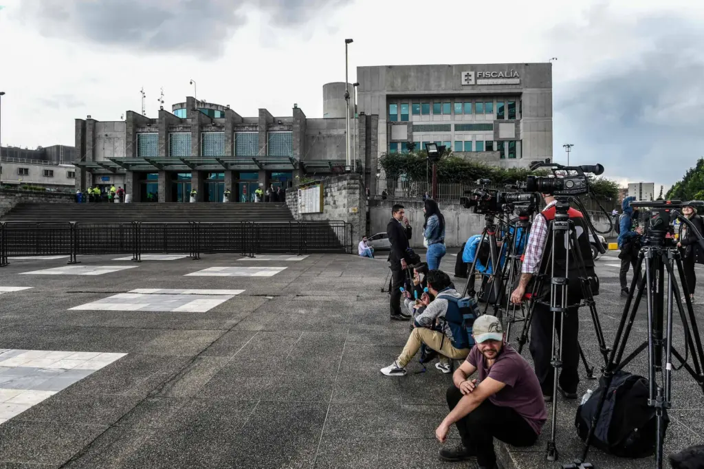 Members of the media wait outside the prosecutor’s office in Bogotá